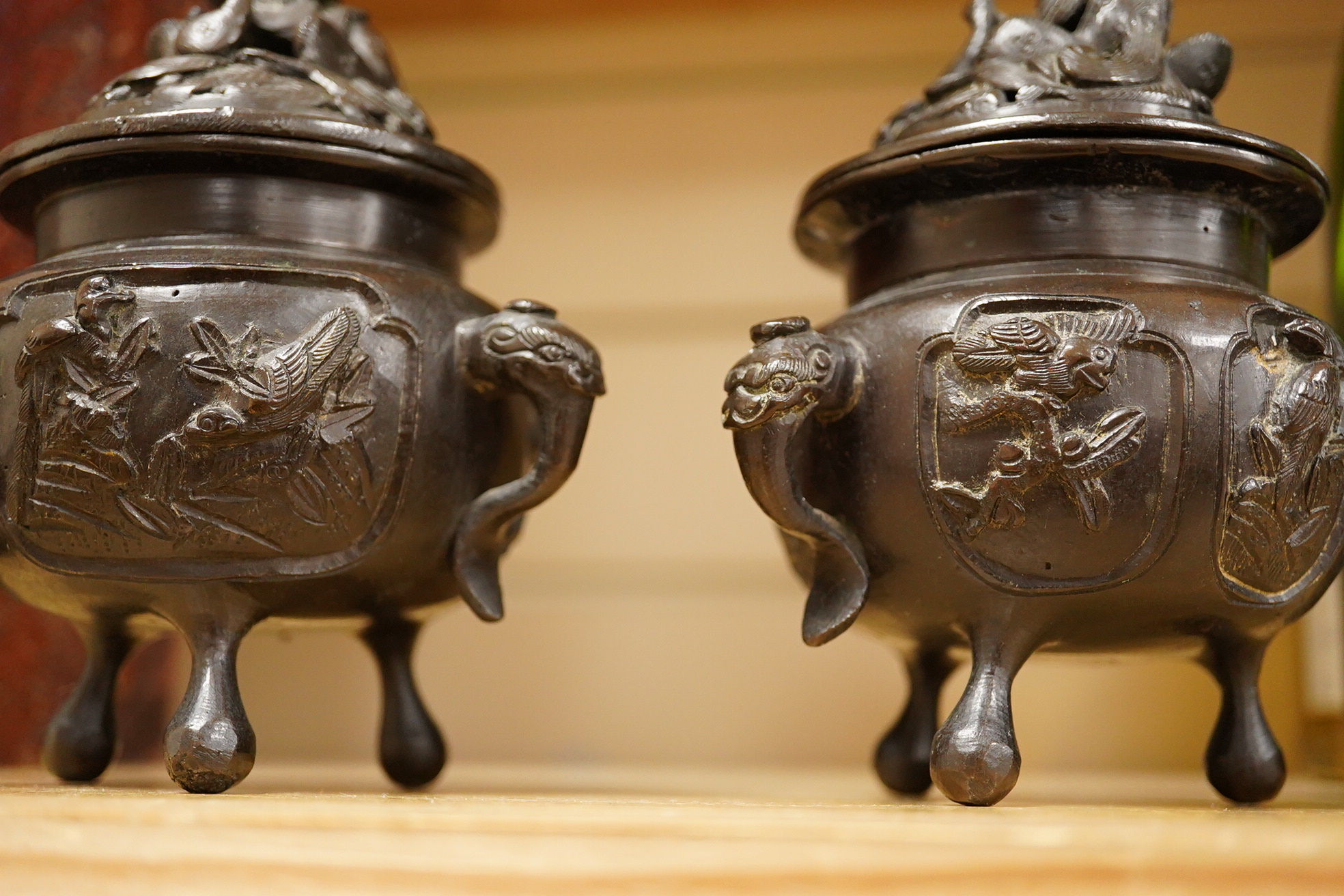A pair of Japanese bronze koros raised on tripod feet, 19th century, 14cm high
